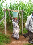 Villager carries a bucket of soil from the pit
