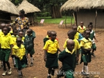 Kenyan school children visit a model of a homestead of the Luo tribe