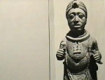 An ancient West African Oni or King holding similar artifacts as the San Agustine culture stone carving of a Shaman